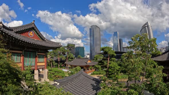 Bongeunsa Temple on summer day with many clouds and skyscrapers