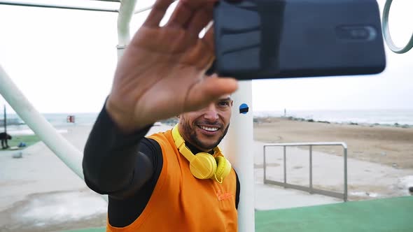 Man training at the beach outdoor gym