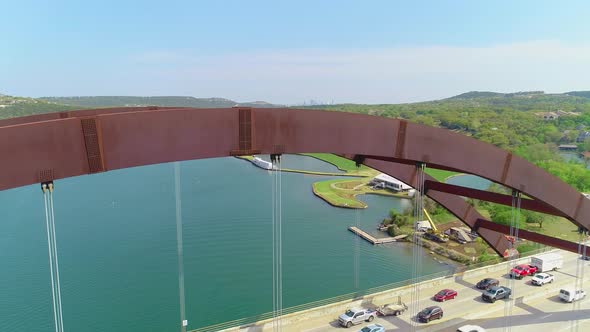 Traffic jam slowly moving across the Pennybacker Bridge with a small view of the city of Austin, Tex