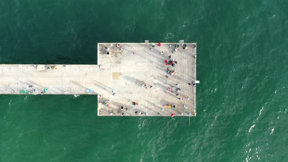 Tourists At The Hermosa Beach Pier Overlooking The Pacific Ocean In Southern California, USA. aerial