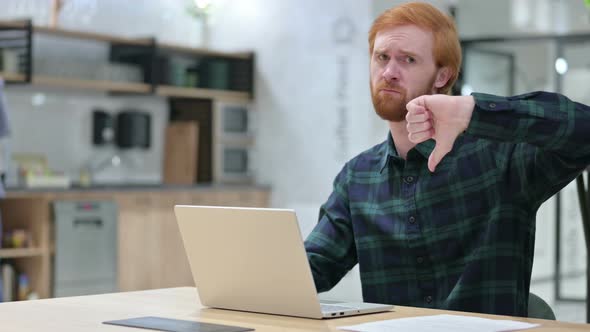 Young Beard Redhead Man with Laptop Showing Thumbs Down 