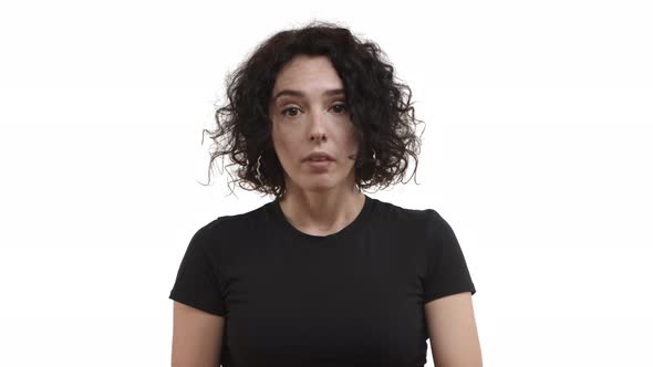 Annoyed Young Woman with Short Curly Hair Wearing Black Tshirt Tap on Wrist and Telling to Hurry Up