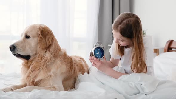 Girl with Clock and Golden Retriever Dog
