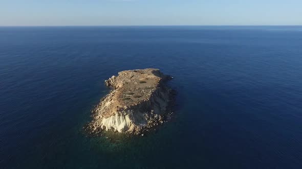 Aerial drone shot flying over the uninhabited island of Yeronisos Sacred Holy Island off the coast o