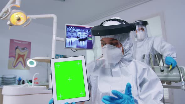 Doctor in Ppe Suit Showing Tablet with Green Screen