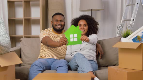 Happy Couple with Boxes Moving To New Home