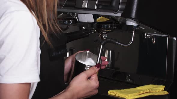 Female Barista Foams Milk for Cappuccino Using Coffee Machine