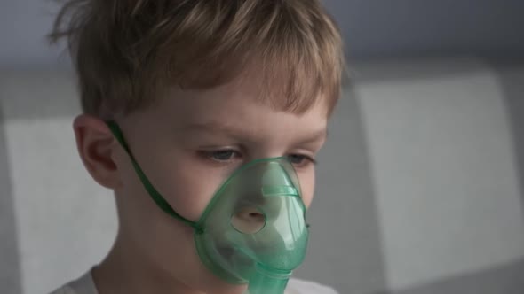 The Boy Make Inhalation Inhales the Medicine Through the Mask Nebulizer Mask