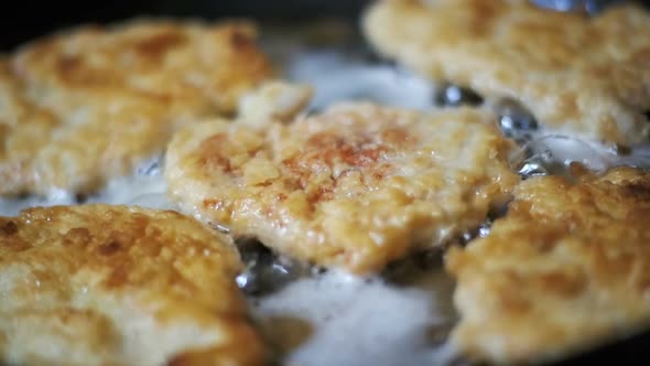 Cooking Meat Chops in a Frying Pan in the Home Kitchen. Slow Motion