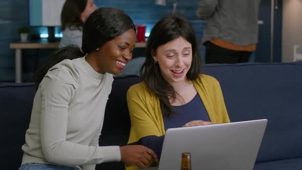 Mixed Race Women Enjoying Time Spend Together Looking at Movie on Laptop