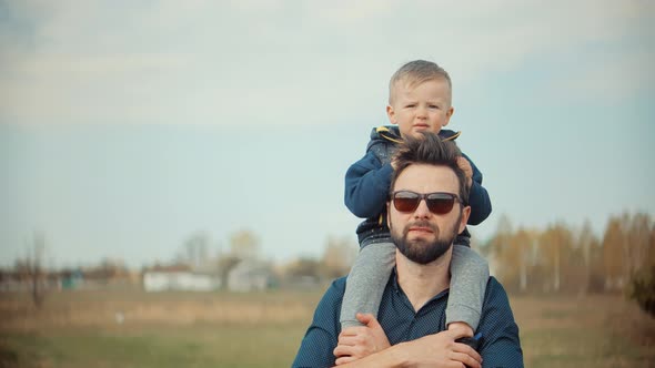 Happy Family Father Day And Child Son Leisure. Boy Son Sitting On Father Neck.  Little Kid Havin Fun