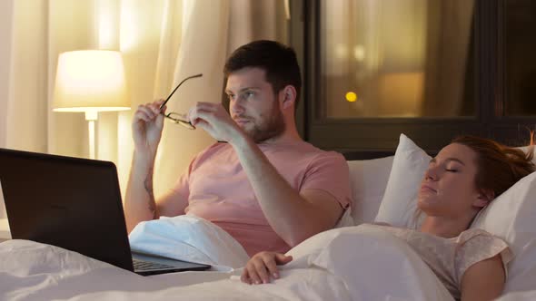 Man in Bed Closing Laptop and Turning Light Off 29