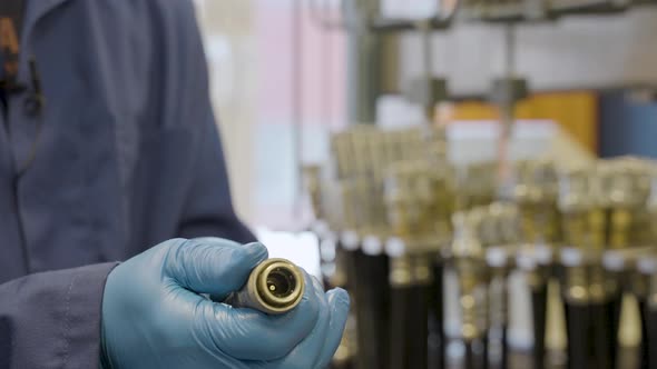 Engineer with gloves checking pressure of hose in industrial Hydraulic Laboratory,close up shot.