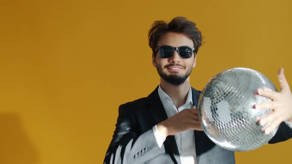 Slow Motion Portrait of Goodlooking Arab Guy Enjoying Party Dancing with Mirrorball