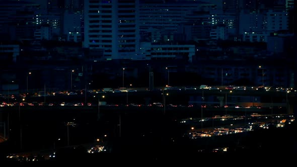 Stream Of Cars Lighting Up City Roads At Night