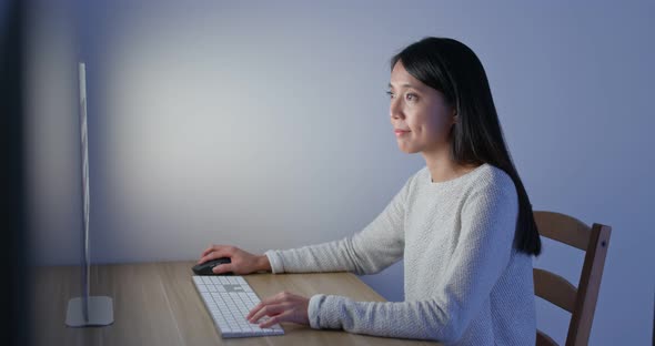 Woman work on computer at home in the evening