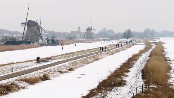 An onwarding aerial footage of a winter landscape following the footpath around the iconic 18th-cent