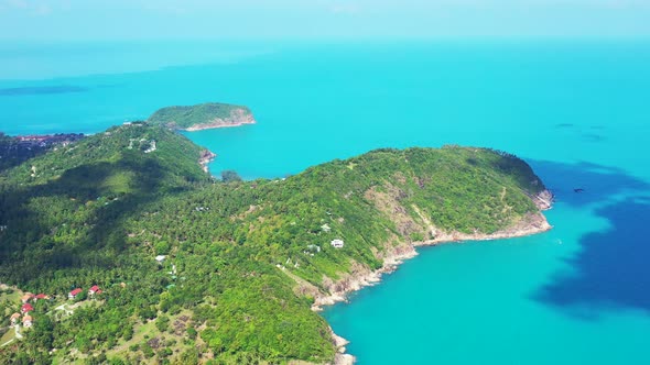 rocky palm tree coast and clear blue water of Siam sea. Thailand.