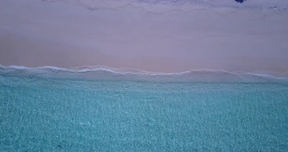 Wide drone travel shot of a white sand paradise beach and aqua turquoise water background in best qu