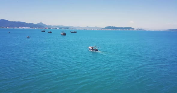 4k Cinematic Shot of Aerial Drone Following Fishing Boat in Paradise Beach