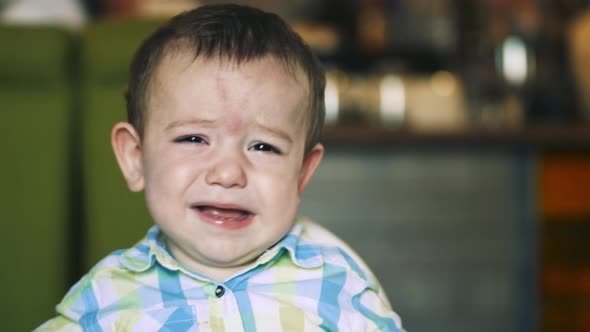 Kid Sits in a Children's Chair, Refuses To Eat Porridge