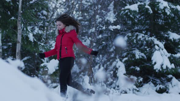 Woman running in the forest on a winter day