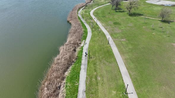 An aerial view over Flushing Meadow Corona Park in Queens, NY on a sunny day. Two people are riding