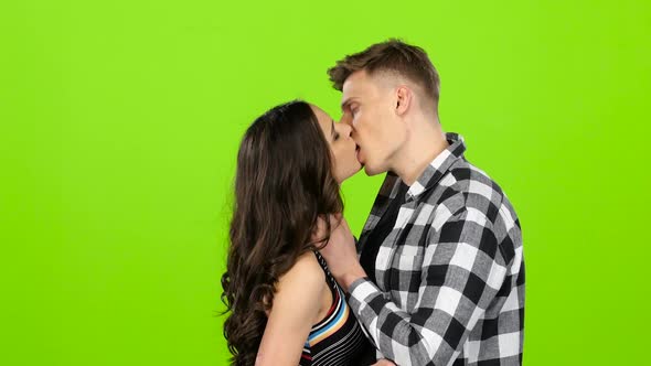 Loving Couple Look at Each Other and Begin To Kiss. Green Screen