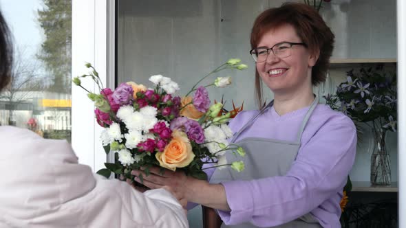 Customer taking an order in flower shop.