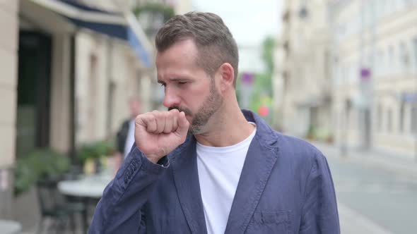 Outdoor Portrait of Sick Mature Adult Man Coughing