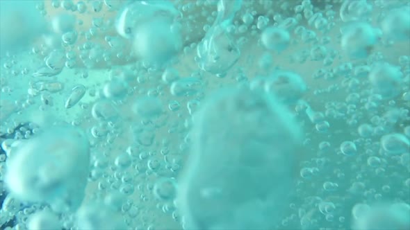 Bubbles floating around a man’s body under water.