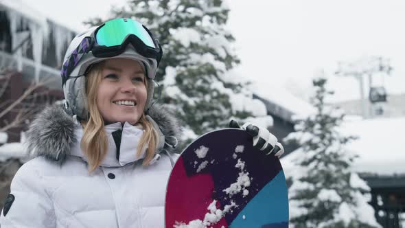 Portrait of Young Woman with Pretty Smile Woman with Snowboard in Ski Resort 6K