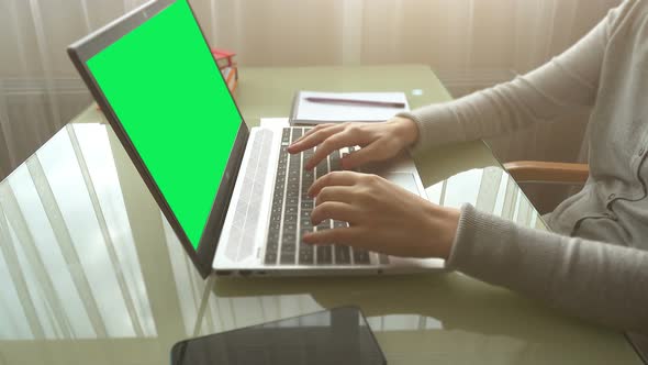 The girl working at home office hands on keyboard