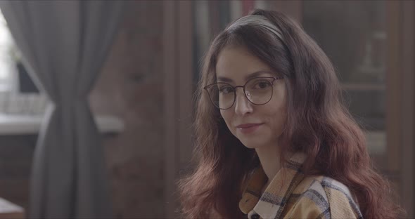 Girl Reads A Book And Then Looks At The Camera