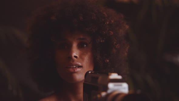 Woman With Afro Hair Filming With Vintage 8Mm Camera