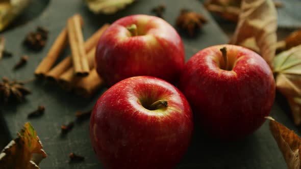 Delicious Fresh Red Apples Placed with Cinnamon and Anise on Dark Wooden Table