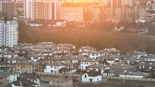 Aerial View of Residential Houses in Suburban Rural Area of Big City at Sunset