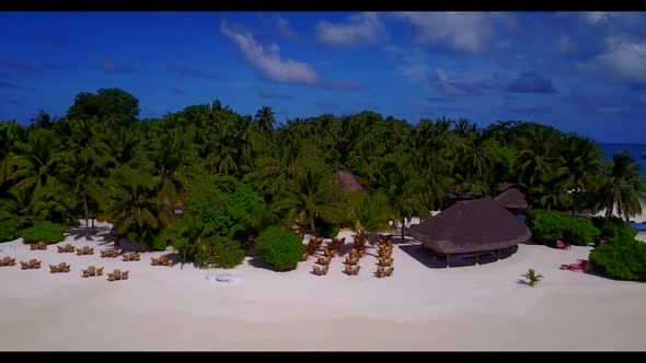 Aerial tourism of tropical coastline beach voyage by blue ocean with white sandy background of a day