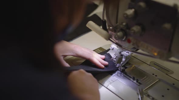 The Seamstress Works on a Sewing Machine at the Factory