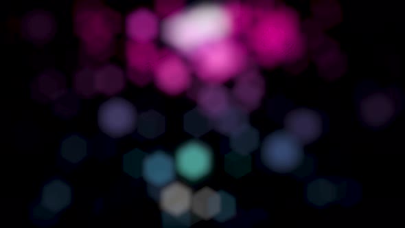 Abstract background of moving bokeh on black background