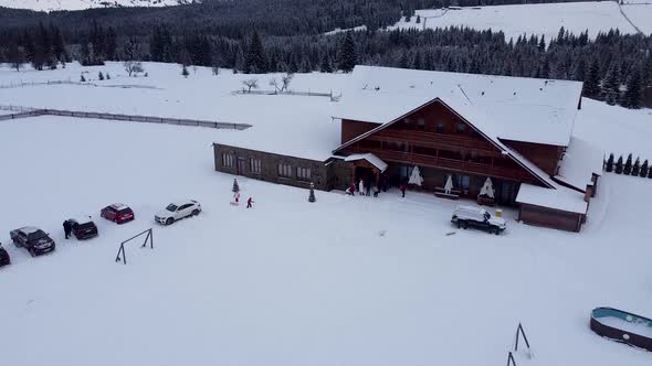 Mountain Wood And Stone Chalet During Winter Covered In Snow