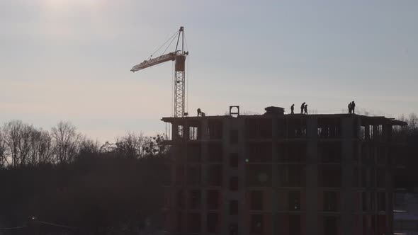 Construction site with big tower crane in time lapse with cloudscape.