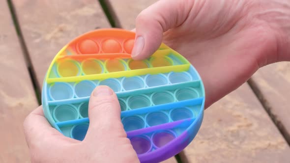 Closeup Shot of a Person Enjoying a Pop It Toy