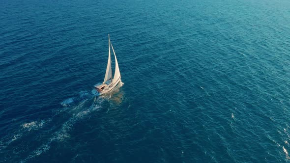 Sailboat in the Ocean. White Sailing Yacht in the Middle of the Boundless Ocean