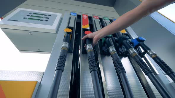 Petrol Pump with a Red-handled Gas Pistol Getting Taken Out From It