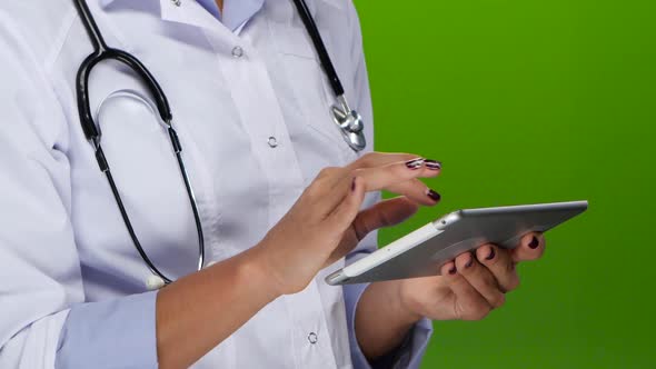 Female Hands Doctors Work on the Tablet Pc. Close Up