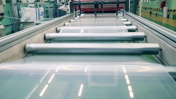 Rolling Conveyor with Plastic Material Going Through It