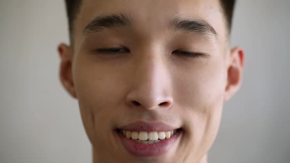 Handsome Asian Man with Dimples Smiles Looking in Camera