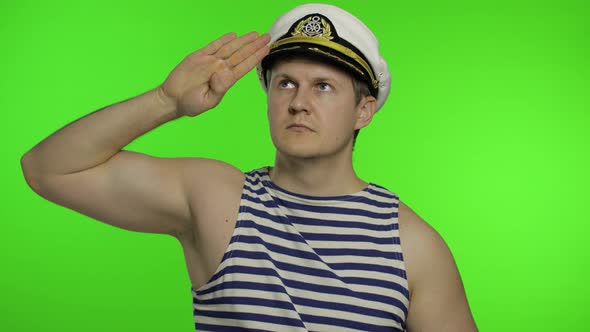 Young Sailor Man Salutes with Hand, Looking Up. Seaman Guy in Sailor's Vests