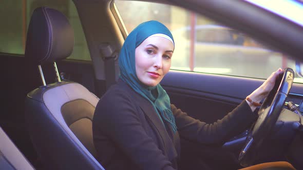 Portrait Muslim Woman in Hijab in Car